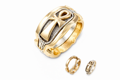 two part gold ring with ankh design on a white background