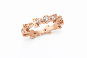Rose Gold Ankh Eternity Band with diamond accents on a white background