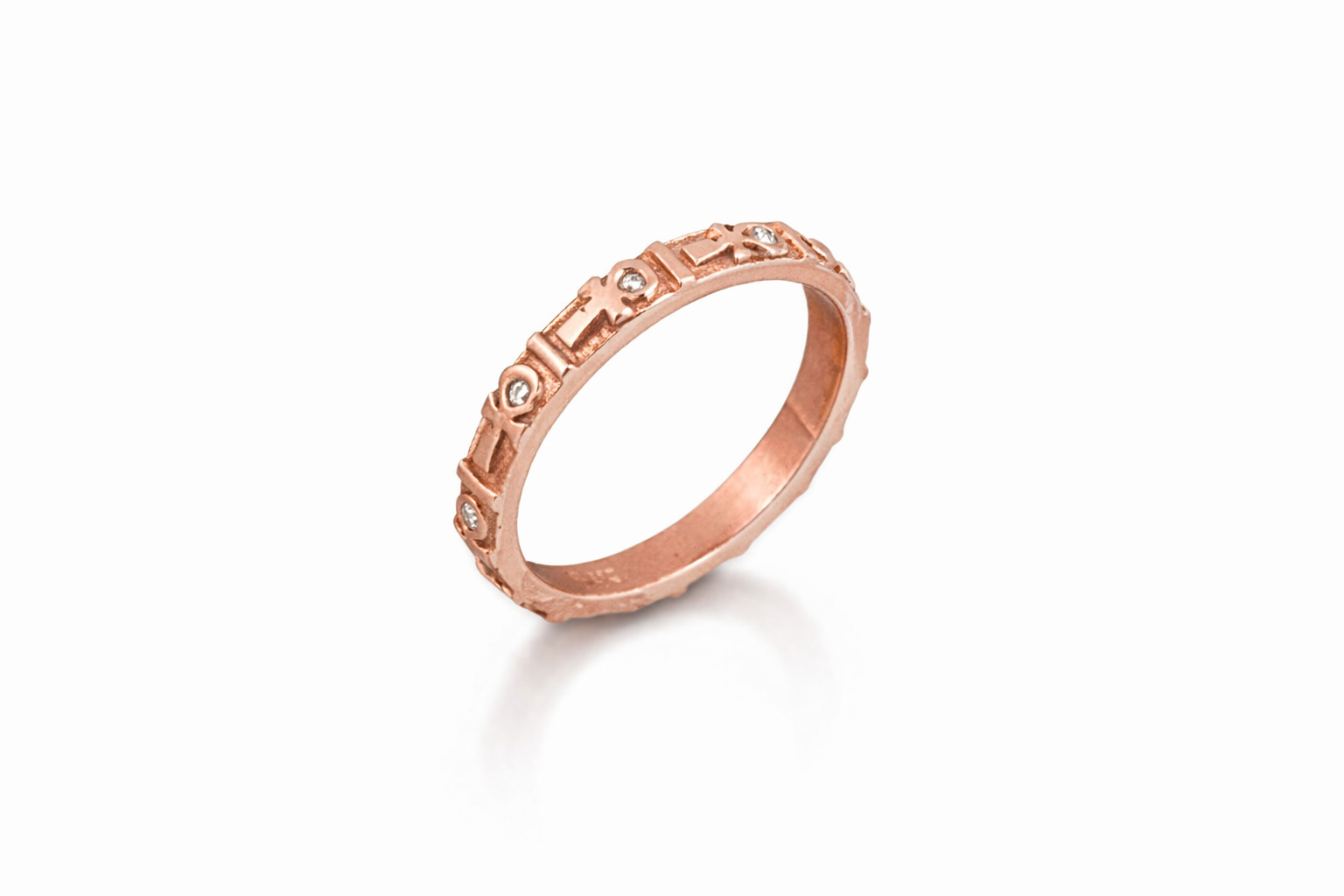 Rose gold ankh band with engraved design on a white background
