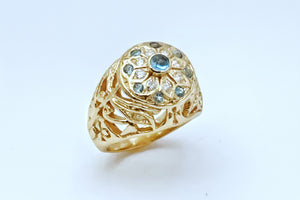 Gold star ring with eyes of Horus and ankh motifs with gemstones on a white background