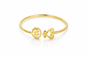 Gye Nyame Sankofa Bangle, a 14k yellow gold Adinkra bangle bracelet with the symbols Gye Nyame and Sankofa on it, featuring white diamonds.