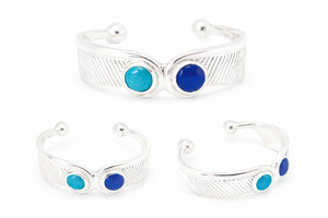 Maat feather cuff with a feather pattern and two large gem stones, with a third image showing the cuff in a different orientation to highlight the design and gemstones.