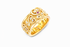 Gold ring with Sankofa adinkra symbols ion it and gemstones on a white background