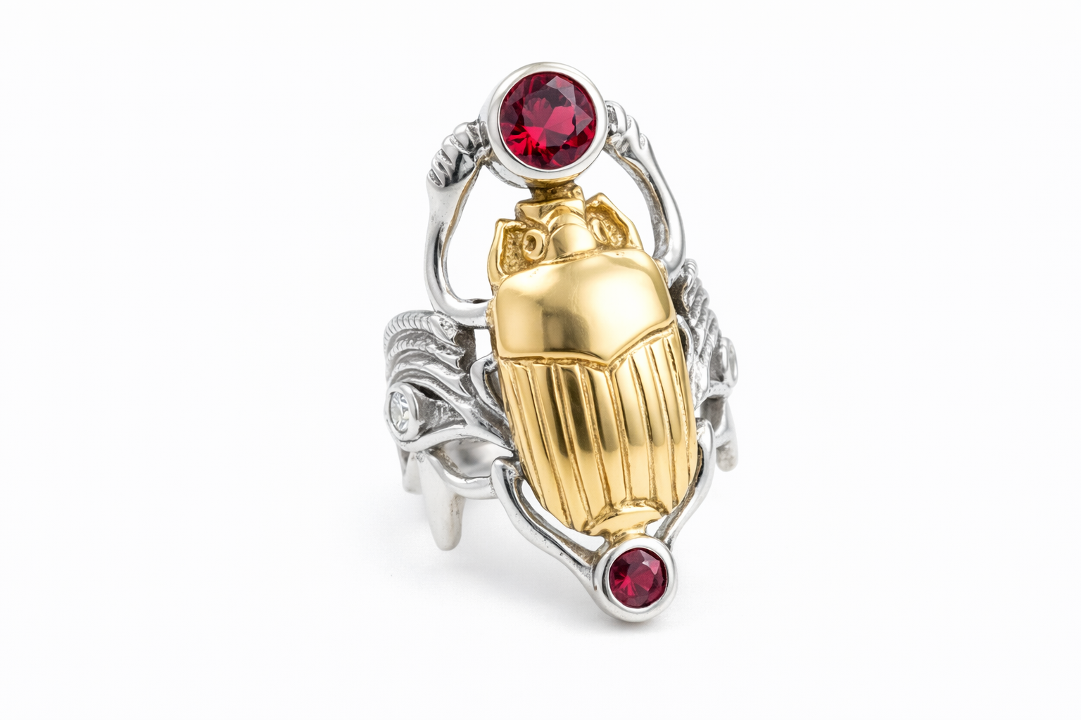 Jewelry ring with gold scarab beetle design with eyes of Heru on the sides on a white background