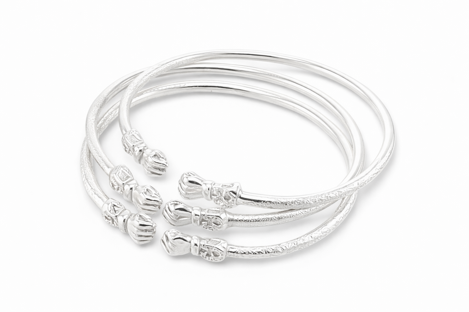 A set of three sterling silver fist bangles with a textured design and ankhs etched in the design.