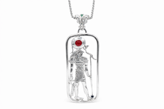A sterling silver pendant featuring a filigree design with a figure of Heru, including Amethyst, carnelian, and emerald stones, attached to a gold-tone chain.