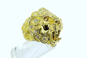 A yellow gold lion ring with a citrine eye and diamond studded mane.