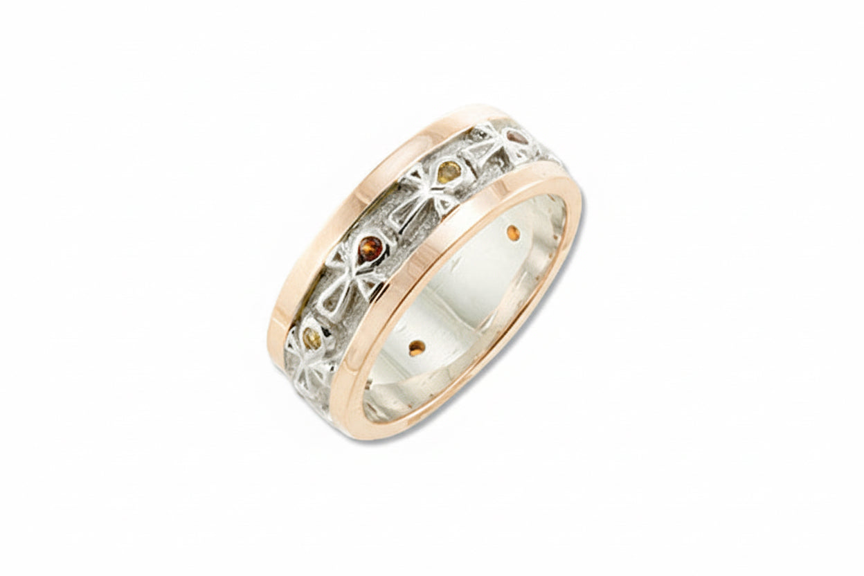 A wedding band ring with yellow gold borders, featuring a series of round cut citrines and yellow topaz set within the band's design.