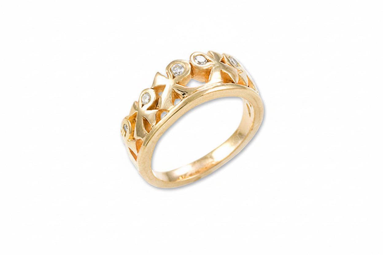 A gold-colored wedding band featuring a geometric design with cascading Ankhs and set with white diamonds.