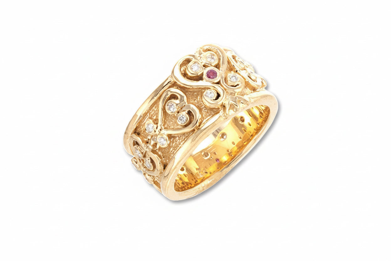 An 18k yellow gold Sankofa wedding band with a vertical Sankofa Adinkra symbol in the center, surrounded by smaller adinkra symbols, set against a textured background. The band is enhanced with small, possibly conflict-free, diamonds.