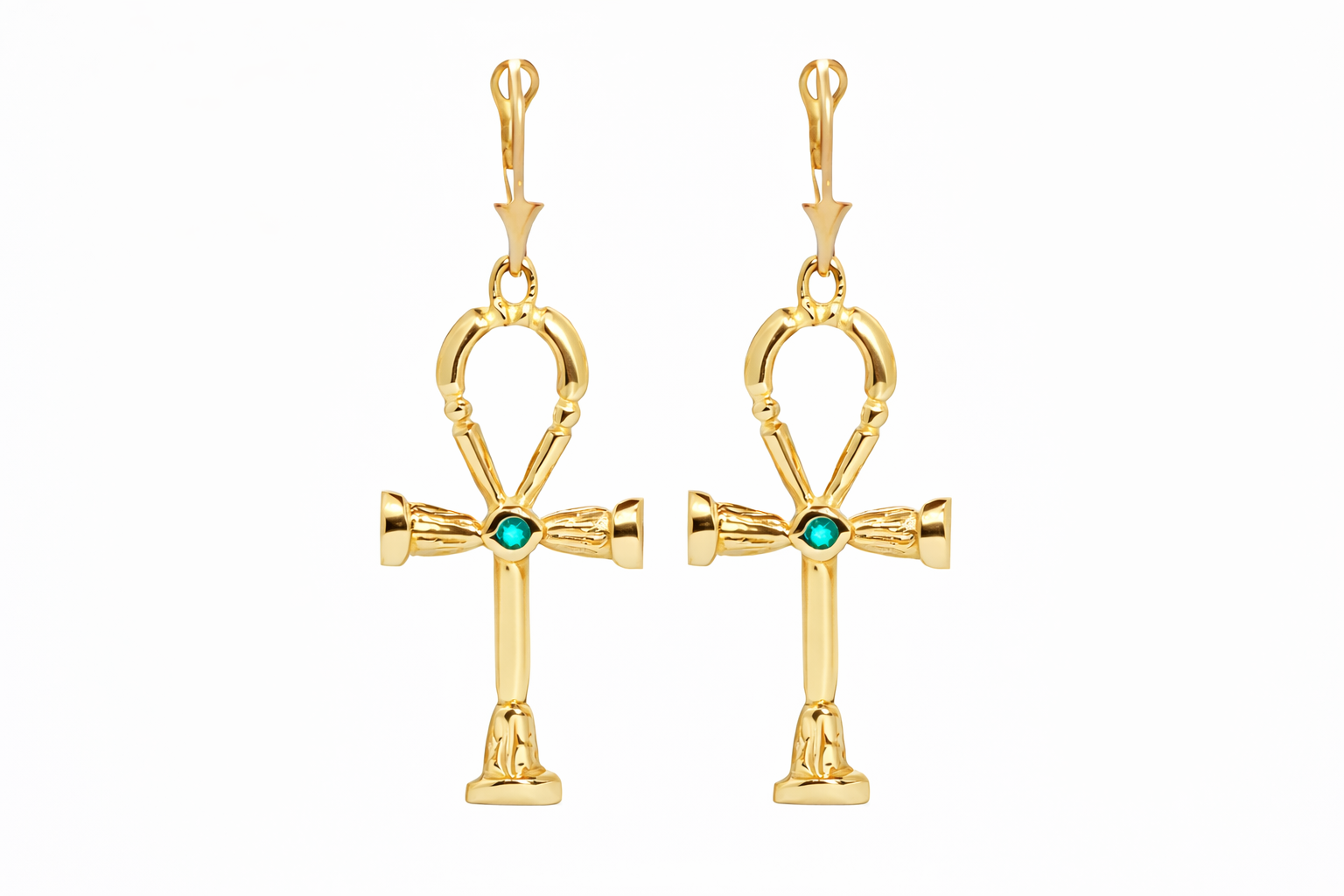 Gold ankh earrings with emerald gemstones on a white background