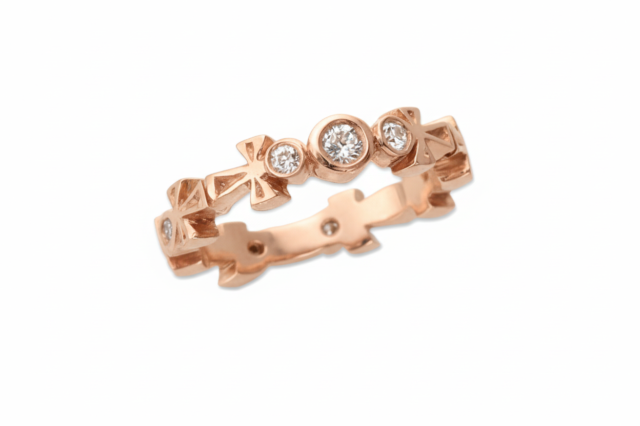 Rose Gold ring with diamond accents on a white background