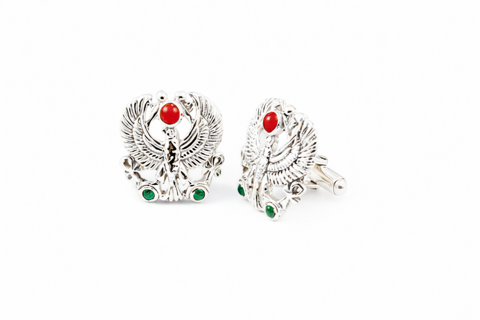Silver falcon cufflinks with red and green accents on a white background