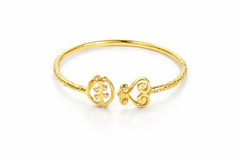Gye Nyame Sankofa Bangle, a 14k yellow gold Adinkra bangle bracelet with the symbols Gye Nyame and Sankofa on it, featuring white diamonds.