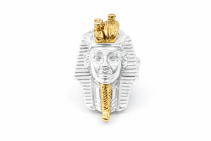 Gold and silver pharaoh head ring on a white background