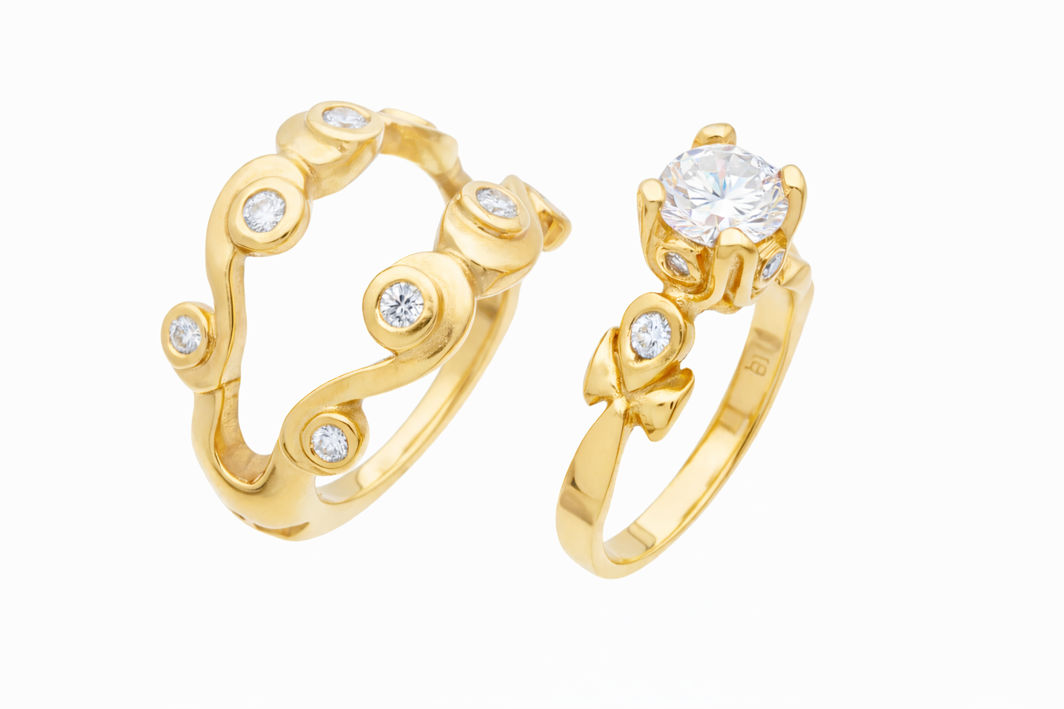 Gold ring set with diamond accents on a white background