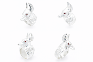 Ring of Anpu, the jacket headed ancient Egyptian principle with red gemstones on a white background