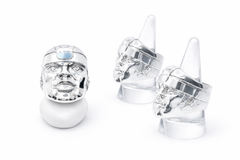 Three silver Olmec head rings on a white background