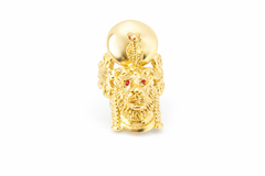Gold lion head ring with ruby stones on a white background