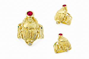 three angles of a 18k Yellow Gold Winged Scarab ring with flanking cobras and wings that make up the band.