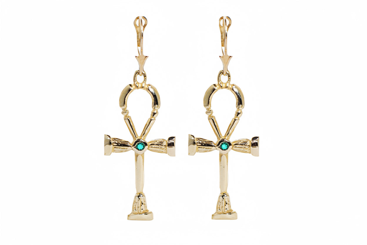 A pair of 14k yellow gold ankh earrings with emeralds, featuring lever backs.