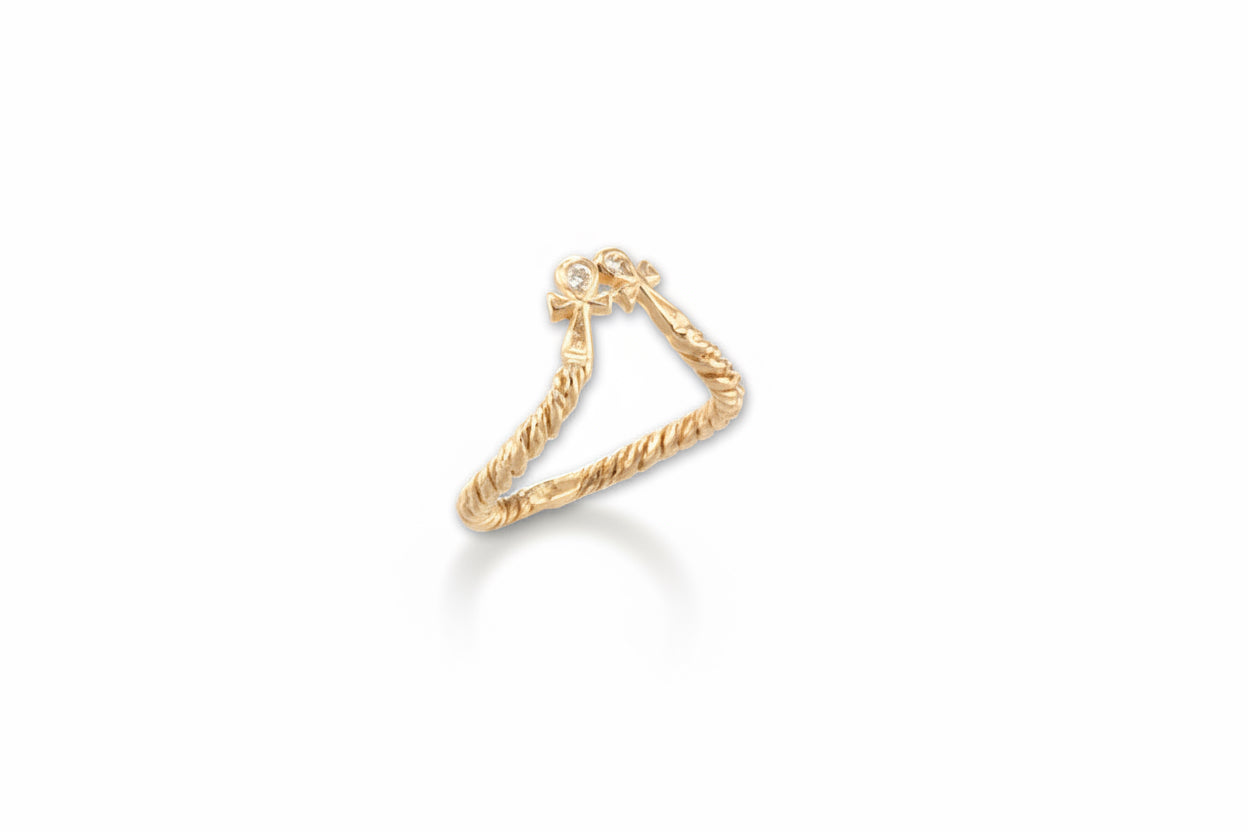 A gold-colored double ankh mini ring with white diamonds, designed to be worn above the mid knuckle of a finger.