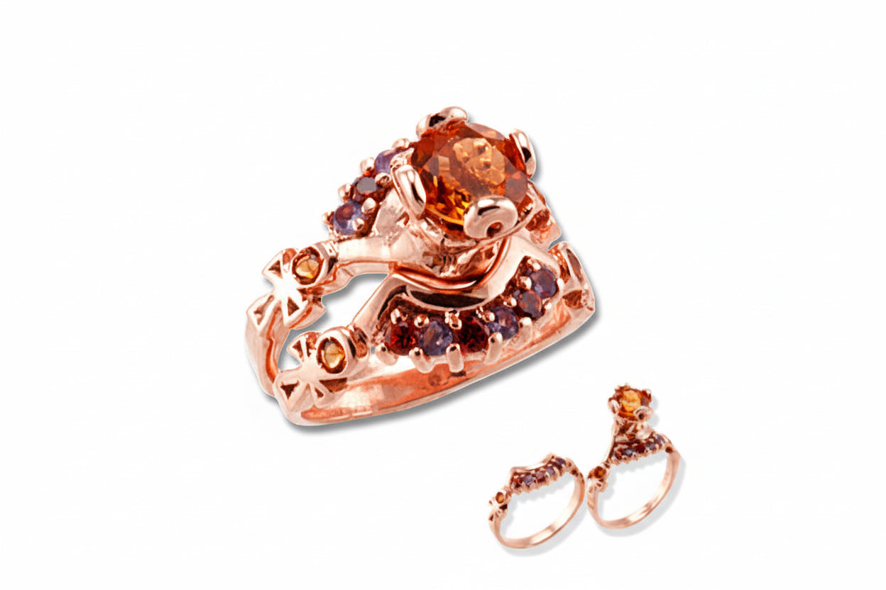 Rose gold ring with gemstones on a white background