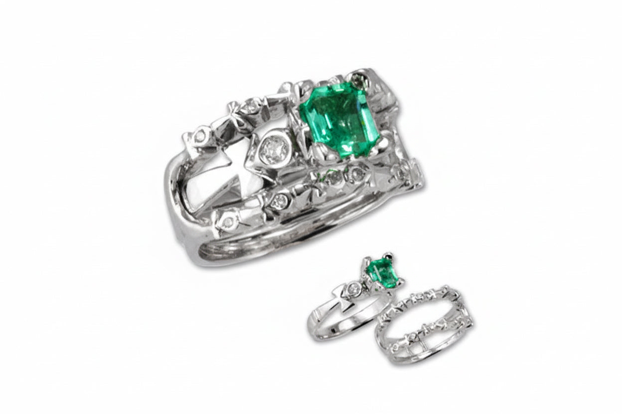 An 18k white gold engagement ring featuring an emerald cut diamond center stone with smaller diamonds around it, and an ankh symbol design.