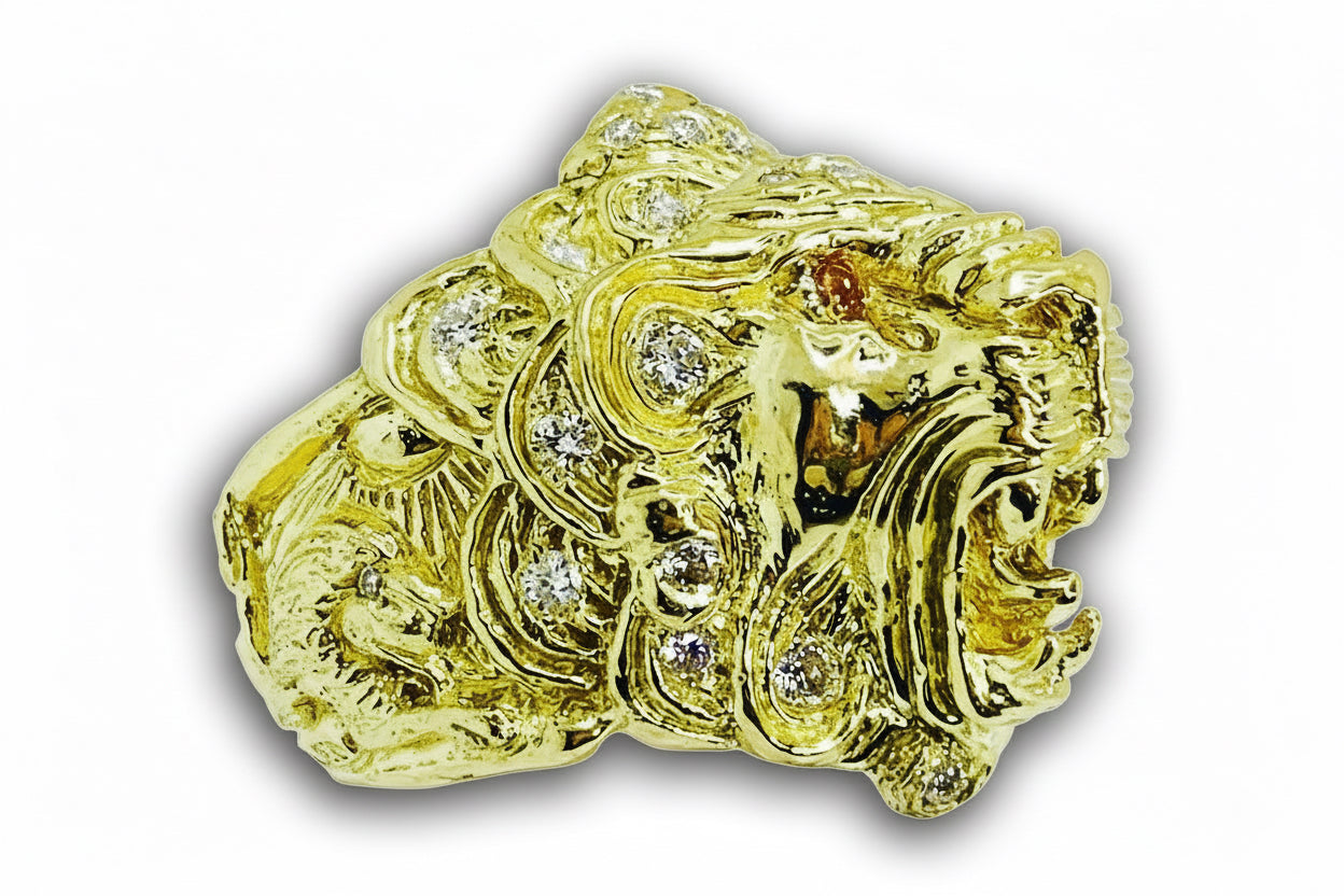 Gold lion head ring with gemstones on a white background