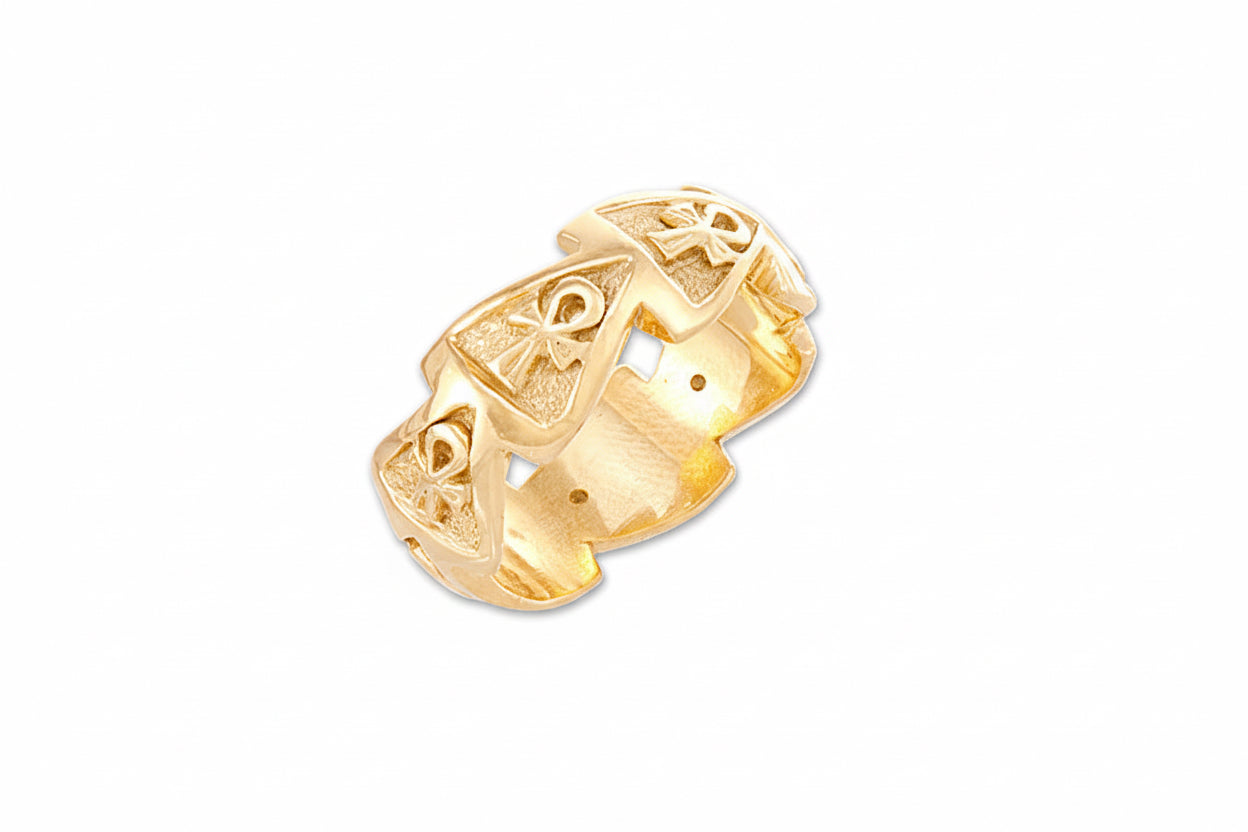 A gold-colored band ring with an Ankh Pyramid design and cut-out spaces with textured backgrounds.